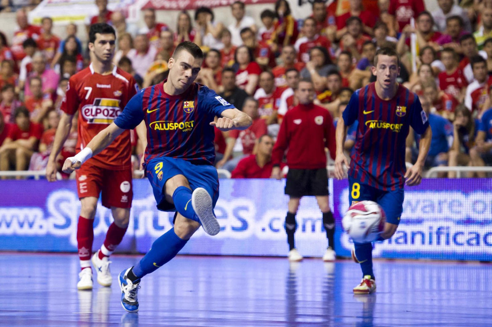 Professional futsal player striking the ball during a match